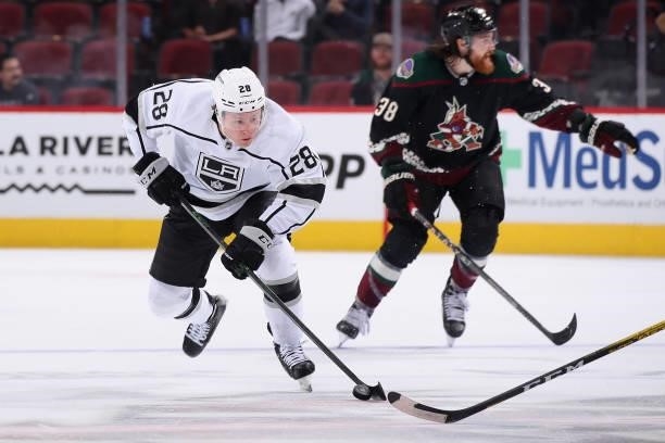 Jaret Anderson-Dolan of the Los Angeles Kings skates with the puck past Liam O'Brien of the Arizona Coyotes during the third period of the preseason...