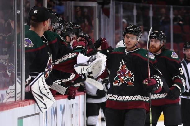 Dylan Guenther of the Arizona Coyotes celebrates with teammates on the bench after scoring a goal during the third period of the preseason NHL game...