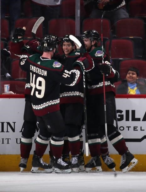 Dylan Guenther of the Arizona Coyotes celebrates with Ty Emberson and Cameron Crotty after scoring a goal against the Los Angeles Kings during the...