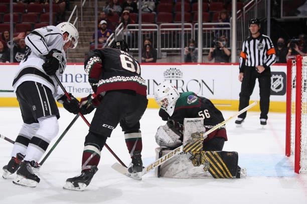 Goaltender Anson Thornton of the Arizona Coyotes makes a save as Arthur Kaliyev of the Los Angeles Kings skates in during the third period of the...