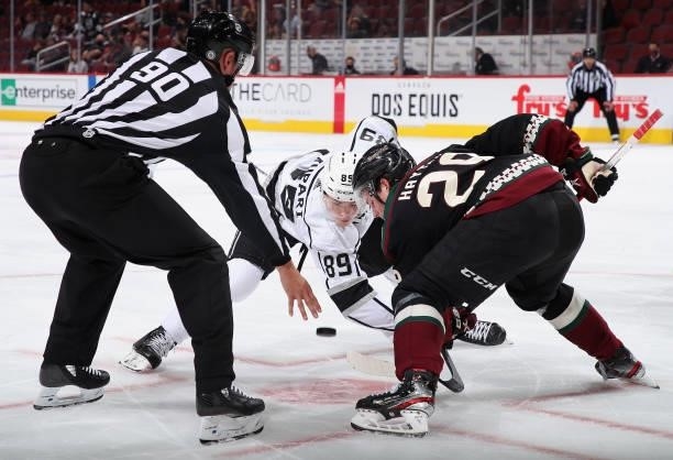 Rasmus Kupari of the Los Angeles Kings faces off against Barrett Hayton of the Arizona Coyotes during the first period of the preseason NHL game at...