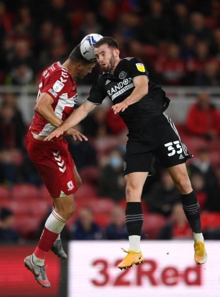 Sheffield United player Rhys Norrington-Davies wins an aerial battle with Daniel Fry during the Sky Bet Championship match between Middlesbrough and...