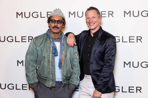 Designer Haider Ackermann and a guest attend the "Thierry Mugler : Couturissime