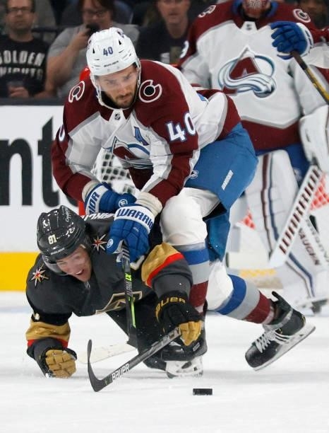 Jonathan Marchessault of the Vegas Golden Knights gets rid of the puck under pressure from Artem Anisimov of the Colorado Avalanche in the first...