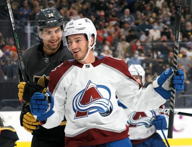Nicolas Hague of the Vegas Golden Knights looks at Jayson Megna of the Colorado Avalanche as he celebrates a first-period goal by teammate Oskar...