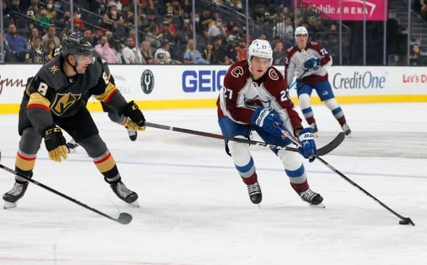 Oskar Olausson of the Colorado Avalanche skates with the puck against Jack Dugan of the Vegas Golden Knights in the first period of their preseason...