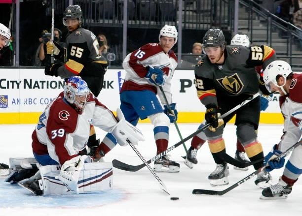 Pavel Francouz of the Colorado Avalanche makes a save against the Vegas Golden Knights as Dylan Coghlan of the Golden Knights looks on in the second...