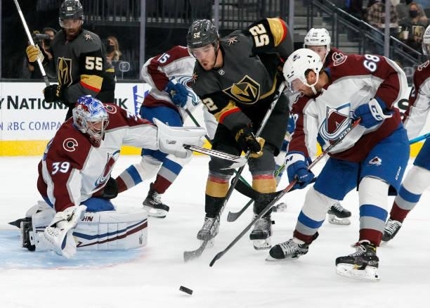 Pavel Francouz of the Colorado Avalanche makes a save against the Vegas Golden Knights as Dylan Coghlan of the Golden Knights and Callahan Burke of...