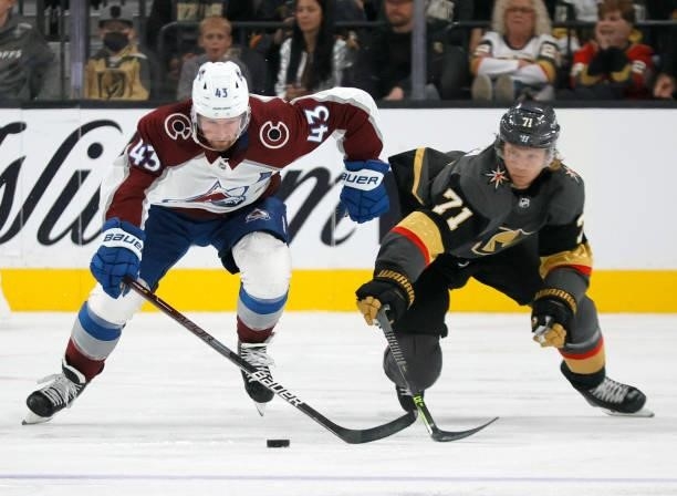 Darren Helm of the Colorado Avalanche skates with the puck against William Karlsson of the Vegas Golden Knights in the third period of their...