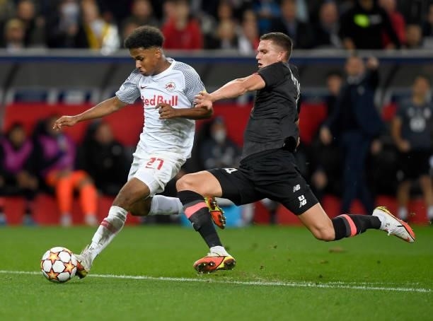 Karim Adeyemi of Red Bull Salzburg is tackled by Sven Botman of Lille OSC during the UEFA Champions League group G match between FC Red Bull Salzburg...