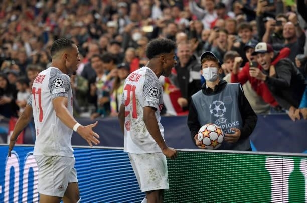 Karim Adeyemi of Red Bull Salzburg celebrates his 1-0 penalty goal with teammate Noah Okafor during the UEFA Champions League group G match between...