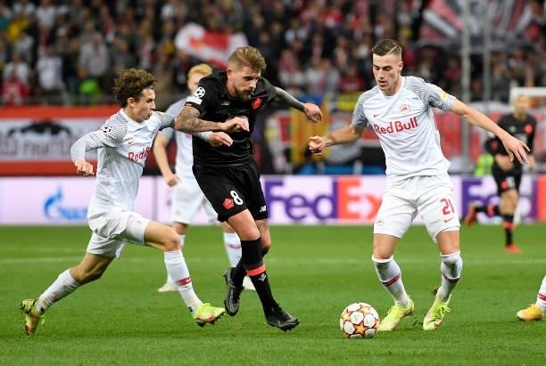 Brenden Aaronson and Luka Sucic of Red Bull Salzburg fight for the ball with Xeka of Lille OSC during the UEFA Champions League group G match between...