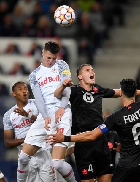 Junior Adamu and Benjamin Sesko of Red Bull Salzburg head for the ball with Sven Botman of Lille OSC during the UEFA Champions League group G match...