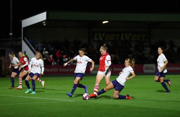 Kim Little of Arsenal is challenged by Molly Bartrip of Tottenham Hotspur during the Vitality Women's FA Cup Quarter Final match between Arsenal and...