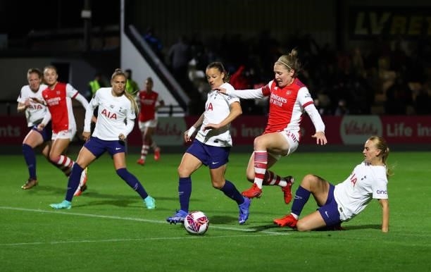 Kim Little of Arsenal is challenged by Molly Bartrip of Tottenham Hotspur during the Vitality Women's FA Cup Quarter Final match between Arsenal and...