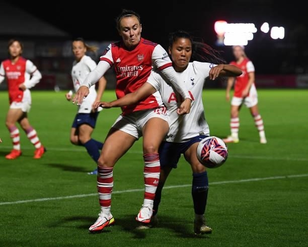 Caitlin Foord of Arsenal challenges Asmite Ale of Tottenham during the Women's FA Cup Quarter Final between Arsenal Women and Tottenham Hotspur Women...