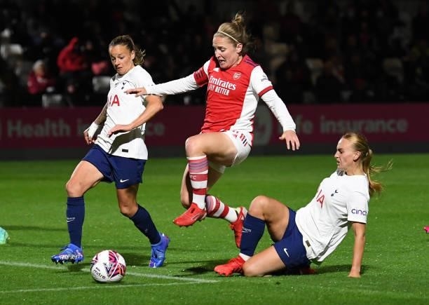 Kim Little of Arsenal jumps between Ria Percival and Molly Bartrip of Tottenham during the Women's FA Cup Quarter Final between Arsenal Women and...