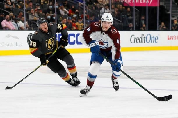 Bowen Byram of the Colorado Avalanche skates with the puck against Patrick Brown of the Vegas Golden Knights in the third period of their preseason...