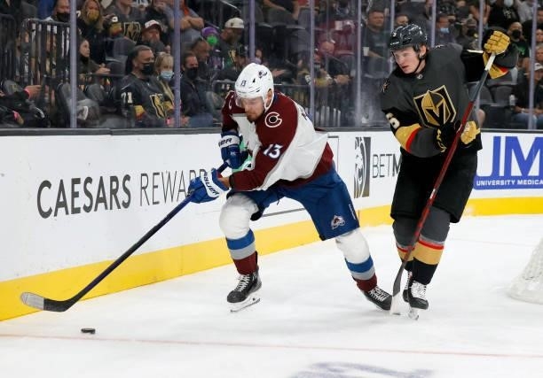 Valeri Nichushkin of the Colorado Avalanche skates with the puck against Kaedan Korczak of the Vegas Golden Knights in the third period of their...