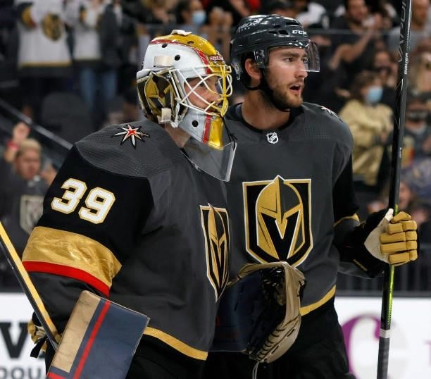 Laurent Brossoit and Nicolas Roy of the Vegas Golden Knights celebrate on the ice after the team's 4-3 victory over the Colorado Avalanche in a...