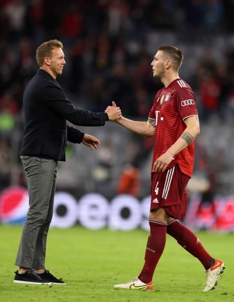 Coach Julian Nagelsmann of Bayern Muenchen with Niklas Suele of FC Bayern Muenchen after the UEFA Champions League group E match between FC Bayern...