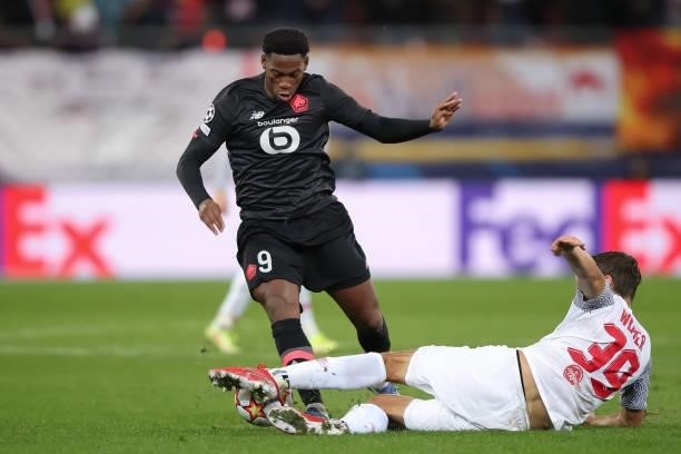 Jonathan David of Lille OSC is tackled by Maximilian Woeber of FC Red Bull Salzburg during the UEFA Champions League group G match between FC Red...