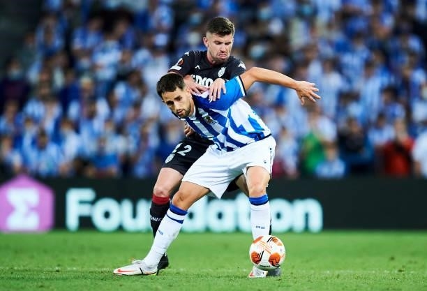 Adnan Januzaj of Real Sociedad duels for the ball with Caio Henrique of AS Monaco during the UEFA Europa League group B match between Real Sociedad...
