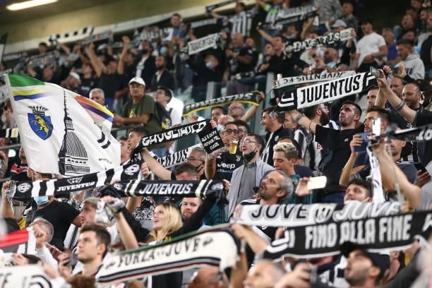 Juventus fans hold up scarves and banners as the club's anthem is played prior to kick off in the UEFA Champions League group H match between...