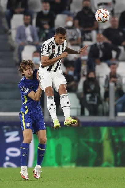 Danilo of Juventus heads clear from Marcos Alonso of Chelsea FC during the UEFA Champions League group H match between Juventus and Chelsea FC at on...