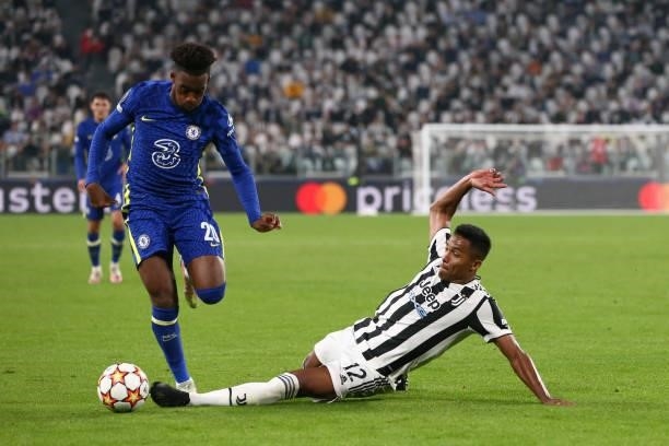 Alex Sandro of Juventus slides in to challenge Callum Hudson-Odoi of Chelsea FC during the UEFA Champions League group H match between Juventus and...