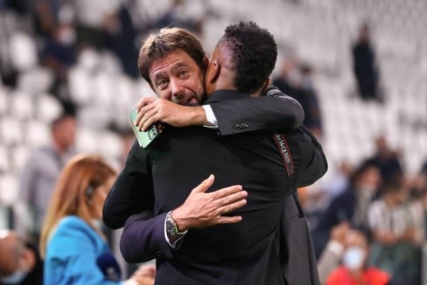 Andrea Agnelli Executive Chairman of Juventus embraces former player Patrice Evra as he commentates for Amazon Prime prior to kick off in the UEFA...