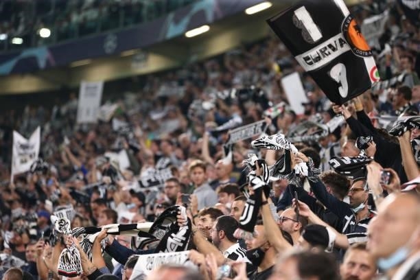 Juventus fans hold up scarves and banners as the club's anthem is played prior to kick off in the UEFA Champions League group H match between...