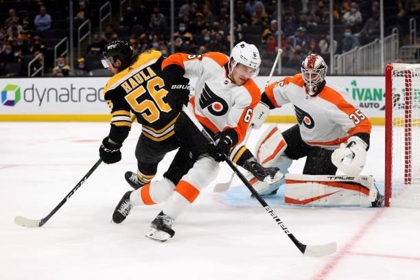Adam Clendening of the Philadelphia Flyers clears the puck away from Erik Haula of the Boston Bruins during the first period of the preseason game at...