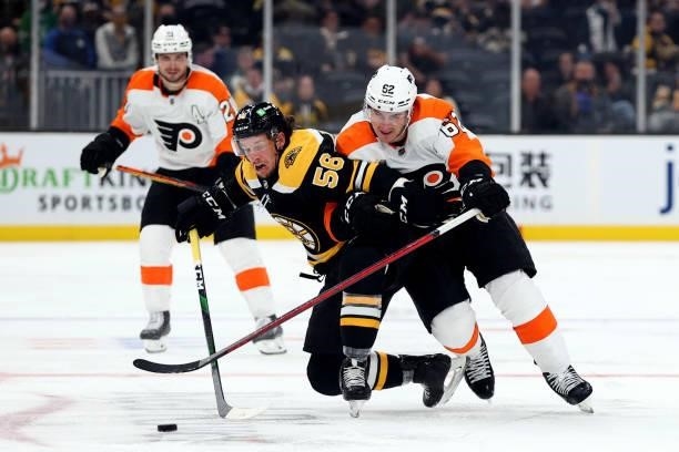 Tyson Foerster of the Philadelphia Flyers defends Erik Haula of the Boston Bruins during the third period of the preseason game at TD Garden on...
