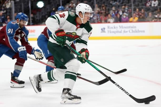 Matthew Boldy of the Minnesota Wild advances the puck the puck against the Colorado Avalanche in the first period at Ball Arena on September 30, 2021...