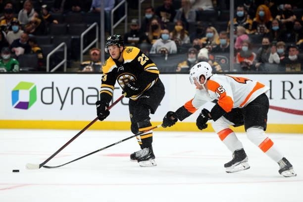 Jack Studnicka of the Boston Bruins skates against Cam York of the Philadelphia Flyers during the tbird period of the preseason game at TD Garden on...
