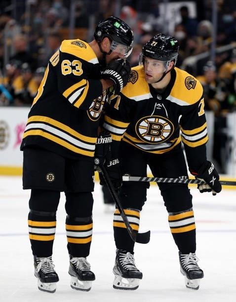 Brad Marchand of the Boston Bruins talks with Taylor Hall during the first period against the Philadelphia Flyers of the preseason game at TD Garden...