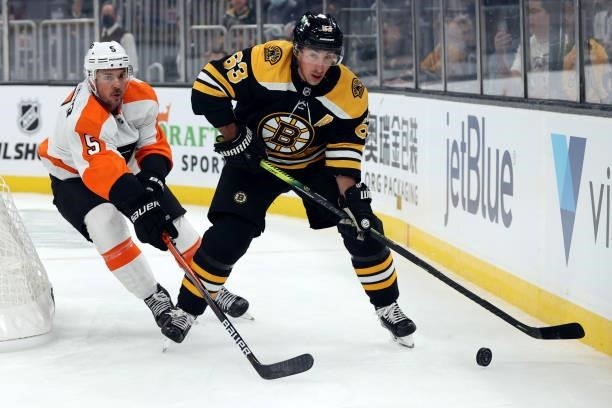 Brad Marchand of the Boston Bruins skates past Adam Clendening of the Philadelphia Flyers during the first period of the preseason game at TD Garden...