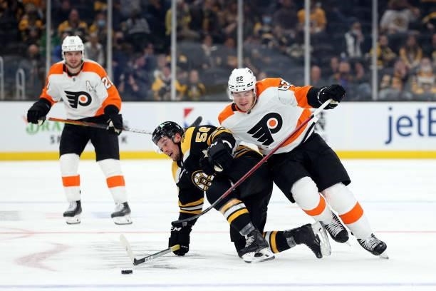 Tyson Foerster of the Philadelphia Flyers defends Erik Haula of the Boston Bruins during the third period of the preseason game at TD Garden on...