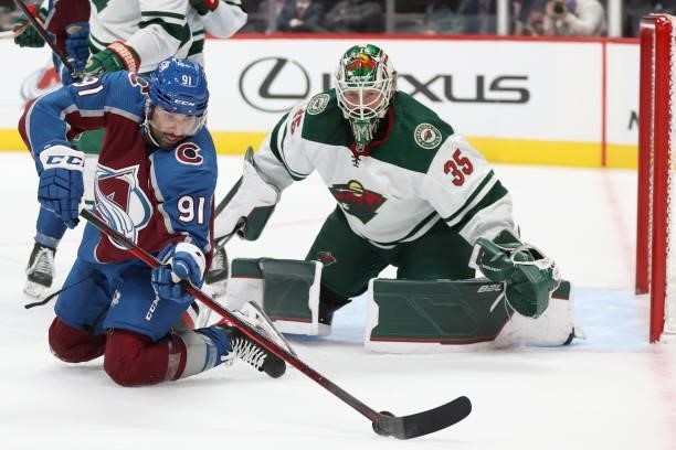 Nazem Kadri of the Colorado Avalanche tries to slide in the puck against goalie Andrew Hammond of the Minnesota Wild in the second period at Ball...