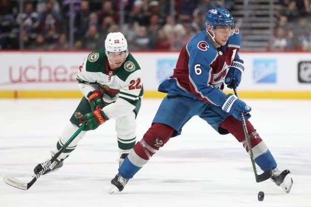 Erik Johnson of the Colorado Avalanche advances the puck against Kevin Fiala of the Minnesota Wild in the second period at Ball Arena on September...