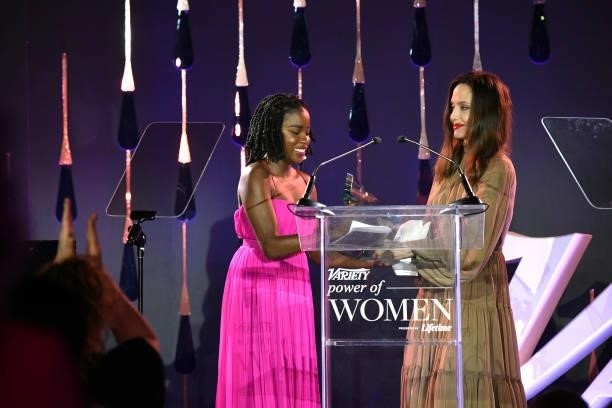 Amanda Gorman accepts an award from Angelina Jolie onstage during Variety's Power of Women on September 30, 2021 in Los Angeles, California.