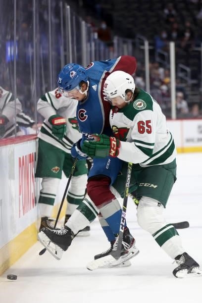 Sampo Ranta of the Colorado Avalanche fights for the puck on the boards against Brandon Duhaime of the Minnesota Wild in the third period at Ball...