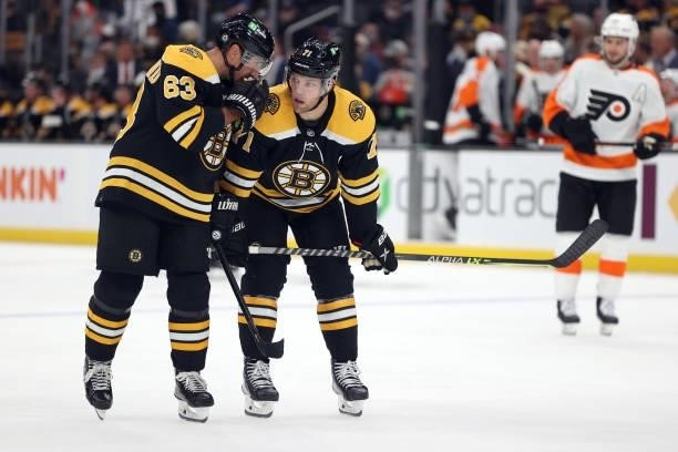 Brad Marchand of the Boston Bruins talks with Taylor Hall during the first period against the Philadelphia Flyers of the preseason game at TD Garden...