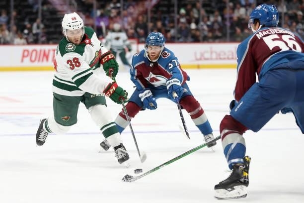 Ryan Hartman of the Minnesota Wild fires a shot on goal against J.T. Compher of the Colorado Avalanche in the third period at Ball Arena on September...