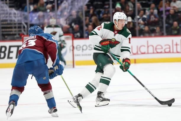 Matthew Boldy of the Minnesota Wild advances the puck against the Colorado Avalanche in the third period at Ball Arena on September 30, 2021 in...