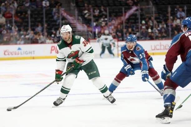Ryan Hartman of the Minnesota Wild advances the puck against the Colorado Avalanche in the third period at Ball Arena on September 30, 2021 in...