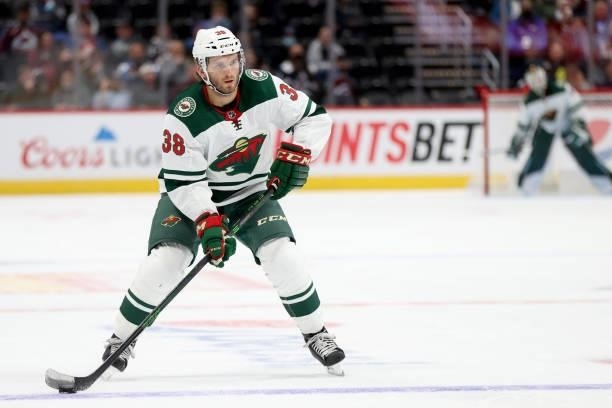 Ryan Hartman of the Minnesota Wild advances the puck against the Colorado Avalanche in the third period at Ball Arena on September 30, 2021 in...