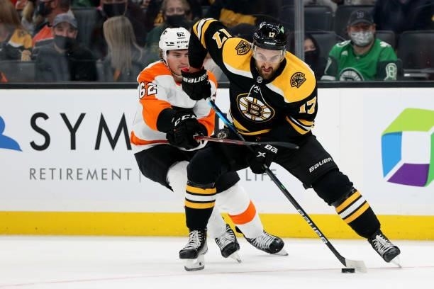 Nick Foligno of the Boston Bruins shields the puck from Nicolas Aube-Kubel of the Philadelphia Flyers during the first period of the preseason game...
