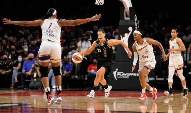 Kelsey Plum of the Las Vegas Aces brings the ball up the court against Kia Vaughn and Shey Peddy of the Phoenix Mercury during Game Two of the 2021...